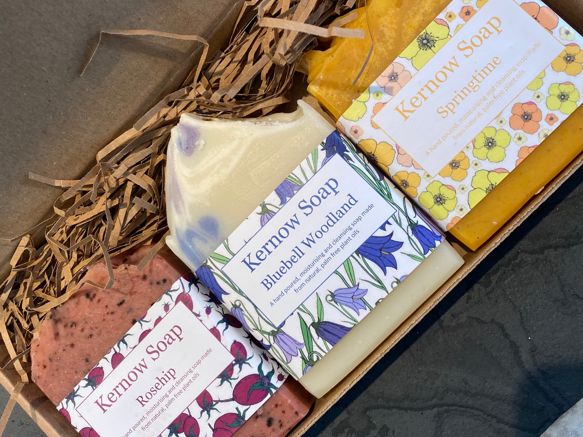 Collection of Kernow Soap bars with labels on a textured surface