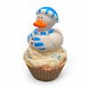 Cupcake with a duck figurine wearing a blue hat and scarf on a white background