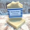 A bar of Cornish Pure soap on a white surface, with a label that reads 'Kernow Soap Cornish Pure'.