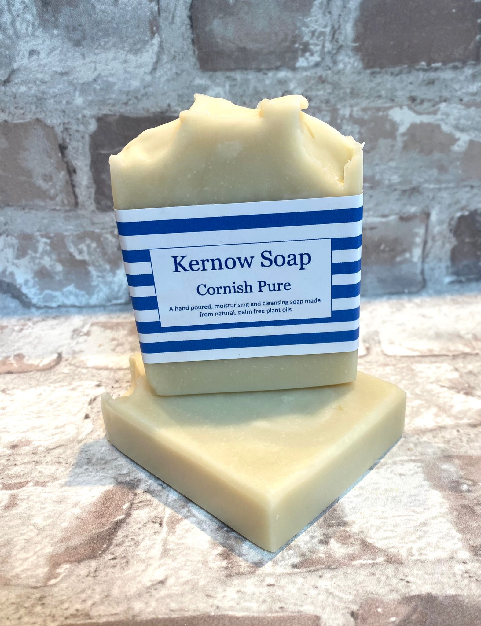 A bar of Cornish Pure soap on a white surface, with a label that reads 'Kernow Soap Cornish Pure'.