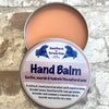 An open Kernow Soap tin container of Hand Balm with a label that includes the product name.