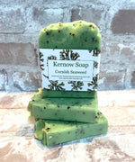 A stack of green, bar-shaped soap with a label in front indicating 'Kernow Soap, Cornish Seaweed'.