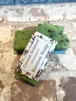 Two half bars of seaweed soap, one labelled, one unlabelled.