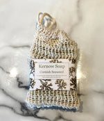 A bar of Kernow soap labelled and in a sisal bag.