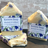 Three bars of Kernow Soap with Bluebell Woodland scent on a stone surface against a brick wall background.