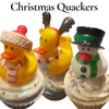 Three cupcakes with Christmas-themed decorations including rubber ducks and a snowman.