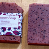 Two bars of Kernow Soap on a beige surface