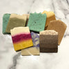 Assorted colorful soap bars on a marble surface
